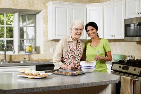 Grapevine senior receiving care at home in a safe home with a smiling and nurturing caregiver