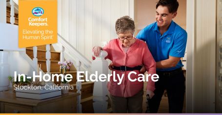 Caregiver helping senior woman down stairs in Stockton