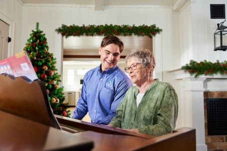 Caregiver and Client playing piano