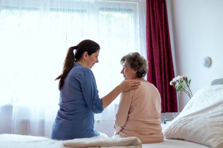 Caregiver playing chess with senior