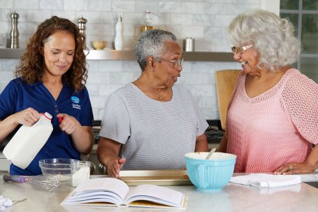 Comfort Keepers Caregiver and client making a meal together.