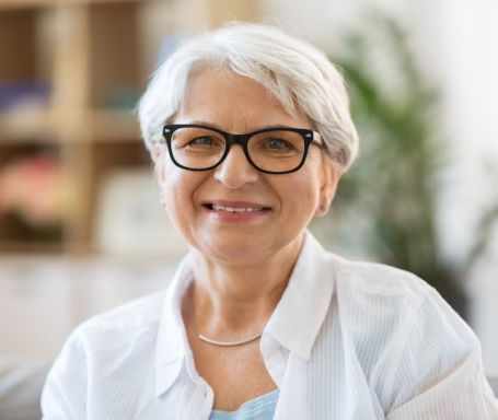 Elderly woman wearing glasses.