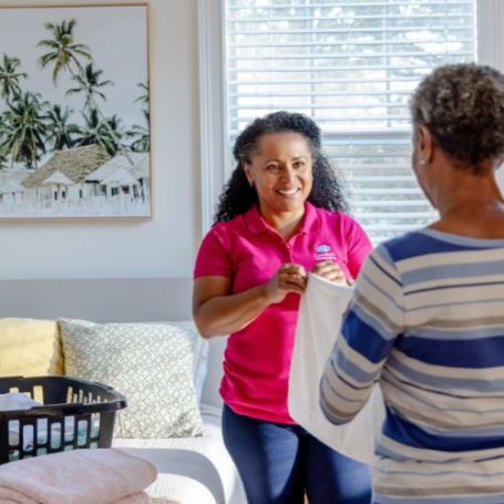 A Comfort Keepers Caretaker helps a client at home.