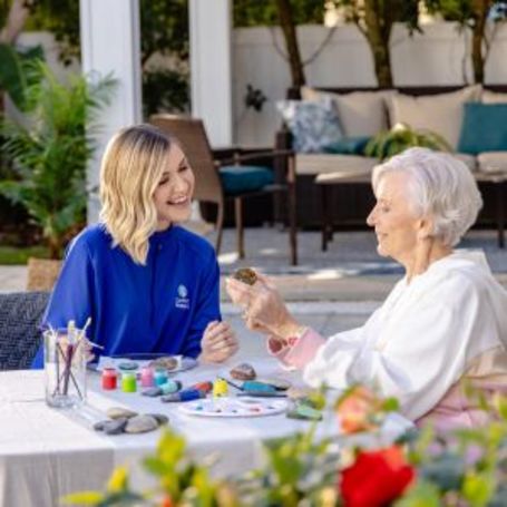 Senior and Comfort Keepers Caregiver spend time painting crafts together.