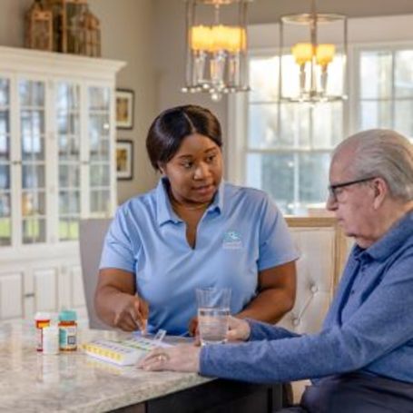 Comfort Keepers Caregiver and client discuss health screenings.