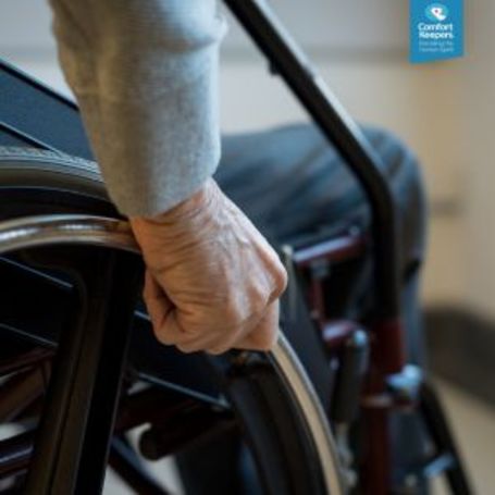 Comfort Keepers senior sits in a wheelchair at home.