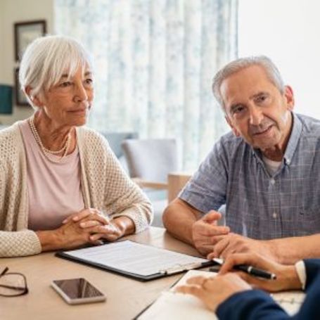Two Comfort Keepers clients learn about financial planning.