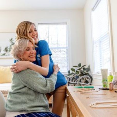 Comfort Keepers Caregiver and Client share a warm embrace.