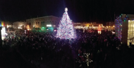 Crowd cheers the lighting of the Christmas tree in Anoka