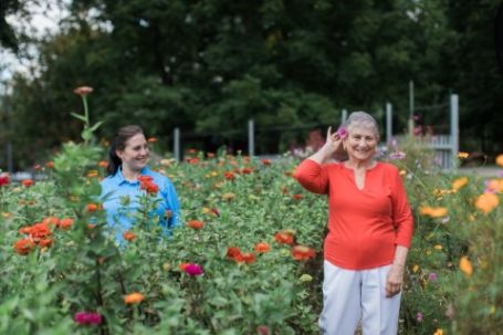 Respite Caregiver and Senior Outside in Backyard of Senior's Home
