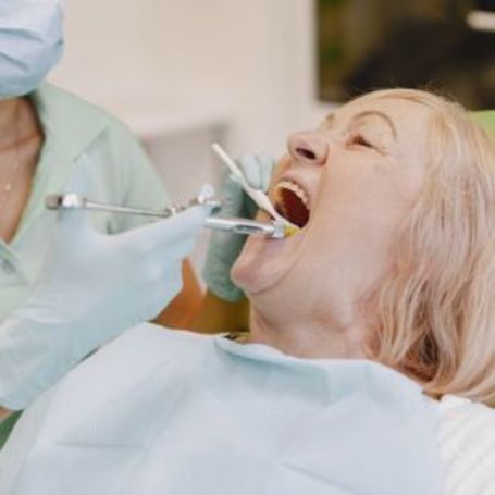 A Comfort Keepers client gets her teeth checked at the dentist