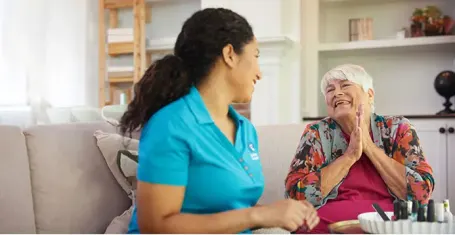 happy senior looking grateful with Comfort Keepers staff