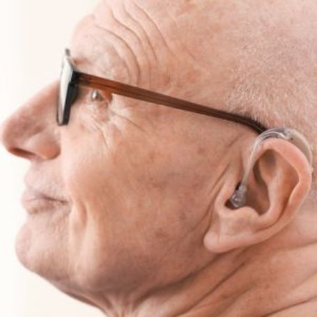 Comfort Keepers senior uses a hearing aide. 