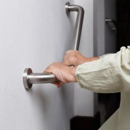 Comfort Keepers senior uses a hand rail