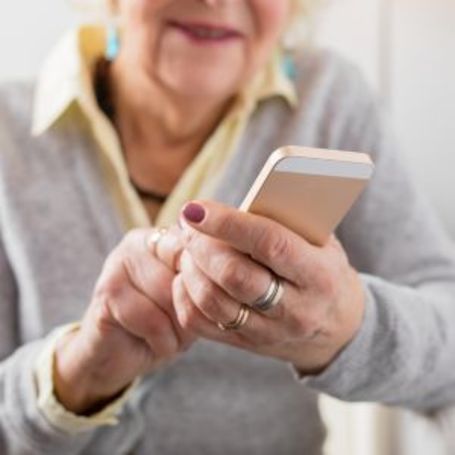 Comfort Keepers in home senior care client uses a phone