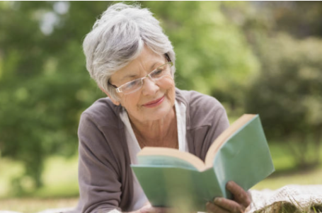 Senior woman reading book outside