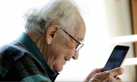 Senior Using his smart phone to communicate