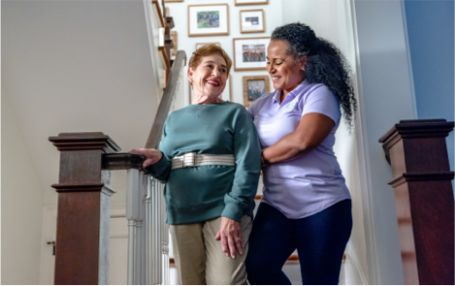 Caregiver assisting senior with mobility at home