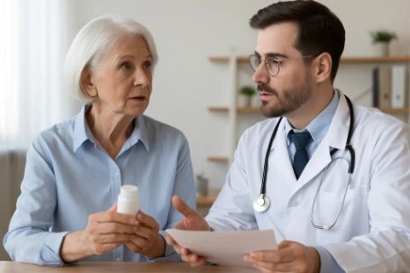 Older adult discussing medication risks with doctor to reduce dementia risk