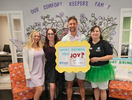 Comfort Keepers Southern Pines staff celebrating National Day of Joy 2025 with group photo and Joy sign
