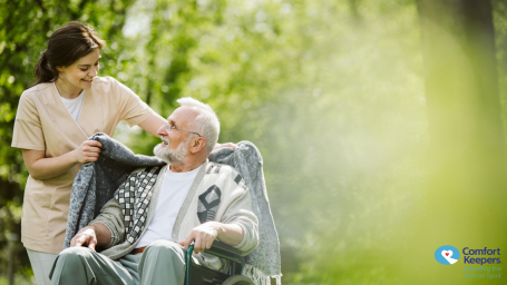 Caregiver smiling caring for an elderly