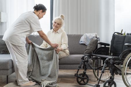 senior woman in Durango receiving respectful bathing assistance from a personal care assistant at home.