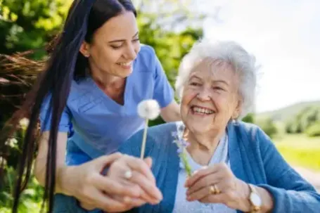 Senior receiving professional caregiver support outside her home in southern pines