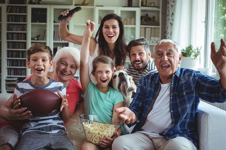 Family cheering and watching TV