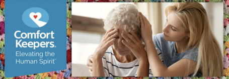 Adult Daughter Comforting Mother with Dementia