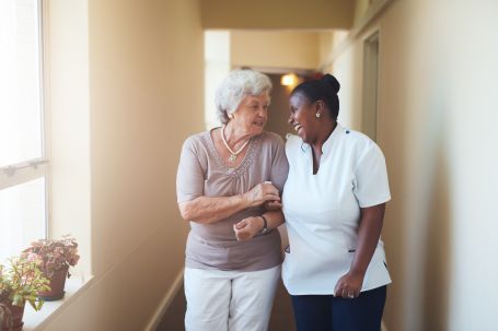 Caregiver Helping Senior After Surgery
