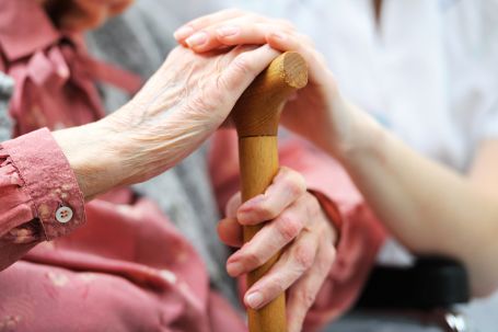 Caregiver holding seniors hand