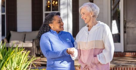 Senior with caregiver for mobility support