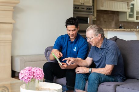 Image of caregiver helping senior with something.