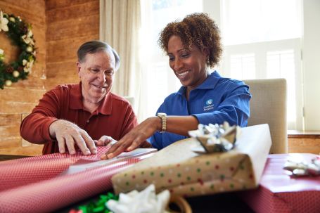 Image of caregiver helping senior with an Activity