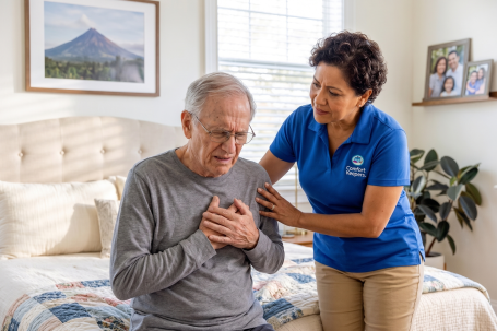 caregiver helping an elderly man