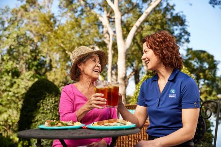 caregiver having a meal with an elderly