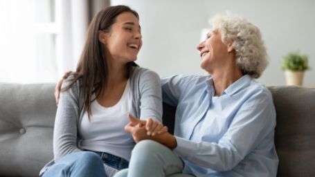 Adult daughter visiting her aging mother at home in Pinehurst NC, discussing personal care support options