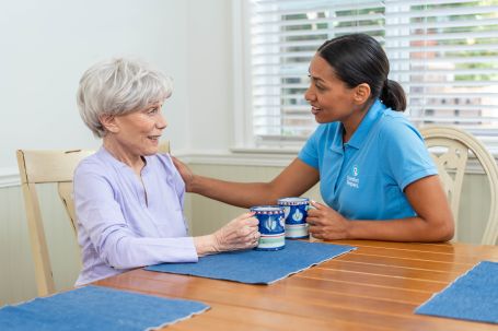 CAREGIVER TALKING TO ELDERLY 
