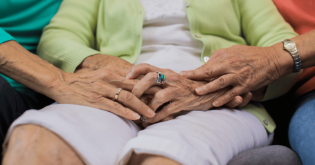 comforting each other with senior's hands
