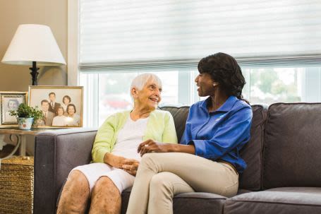 Senior sitting with caregiver