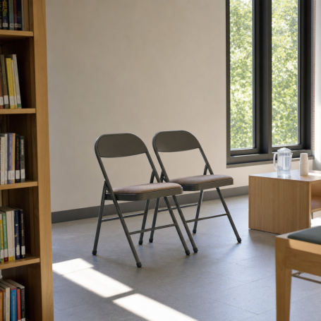 Two empty folding chairs and a water pitcher in a cool, sunlit Phoenix library cooling center