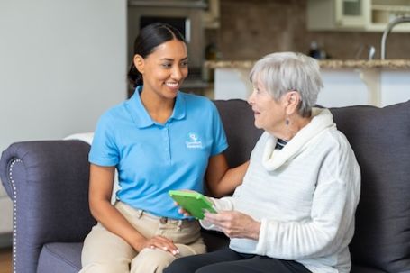 caregiver with client looking at a tablet