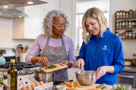 Comfort Keepers caregiver cooking with an older woman in her Gloucester County kitchen