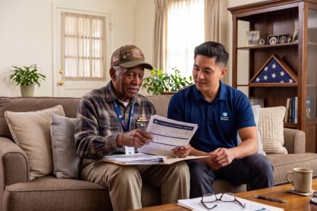 Comfort Keepers caregiver reviewing VA paperwork with an older veteran in Gloucester County