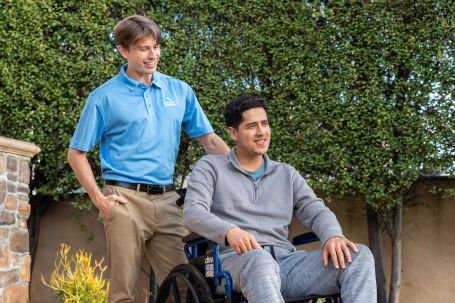 caregiver caring for client in wheelchair