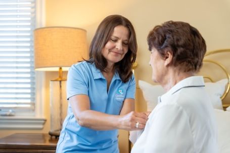 caregiver helping client getting dressed