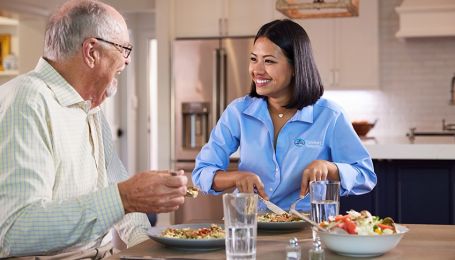 caregiving having a meal with client
