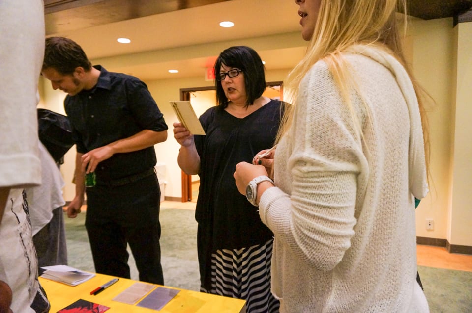 Participants writing on postcards