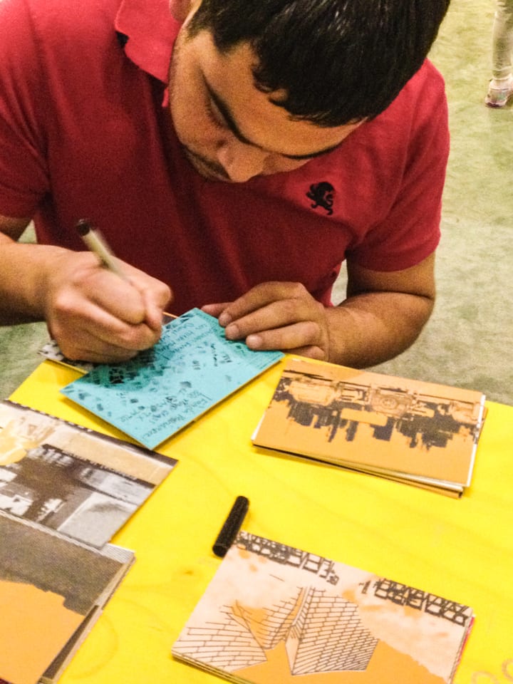 Participants writing on postcards