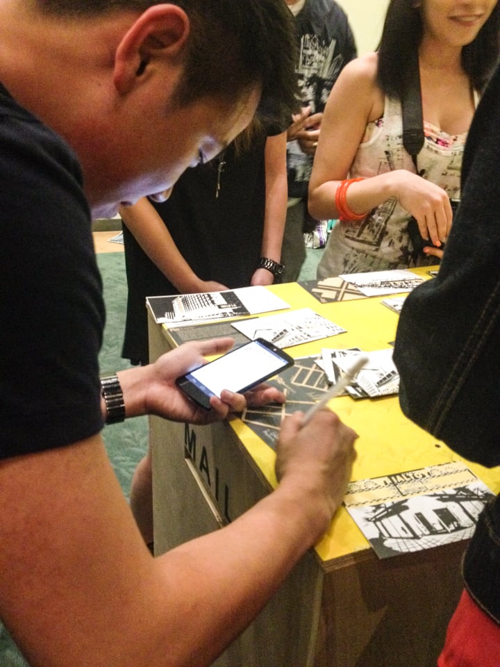 Participants writing on postcards